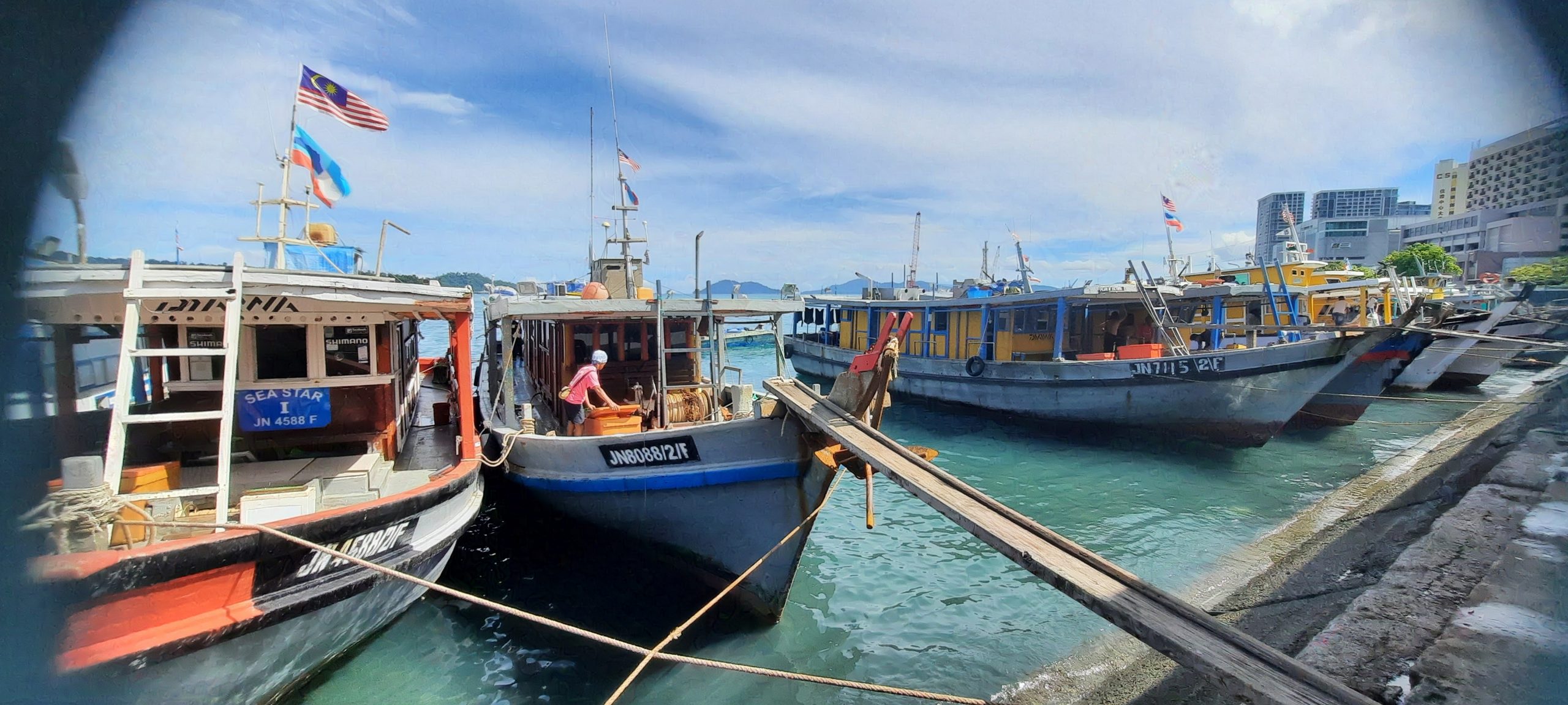 Fishing boats moored by the waterfront of Kota Kinabalu.
