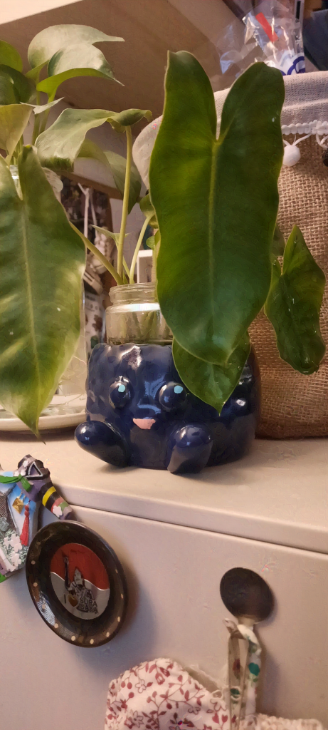 A potted plant in a porcelain pot shaped like the Pokemon, Oddish